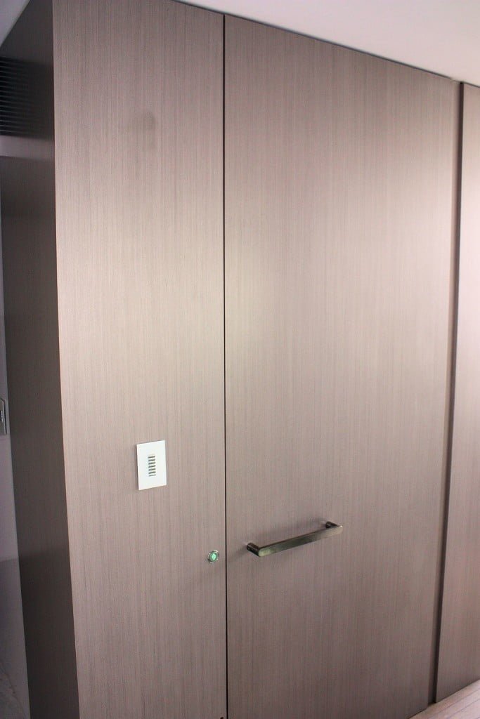 Lift Shop lift door concealed within the surrounding wall finish