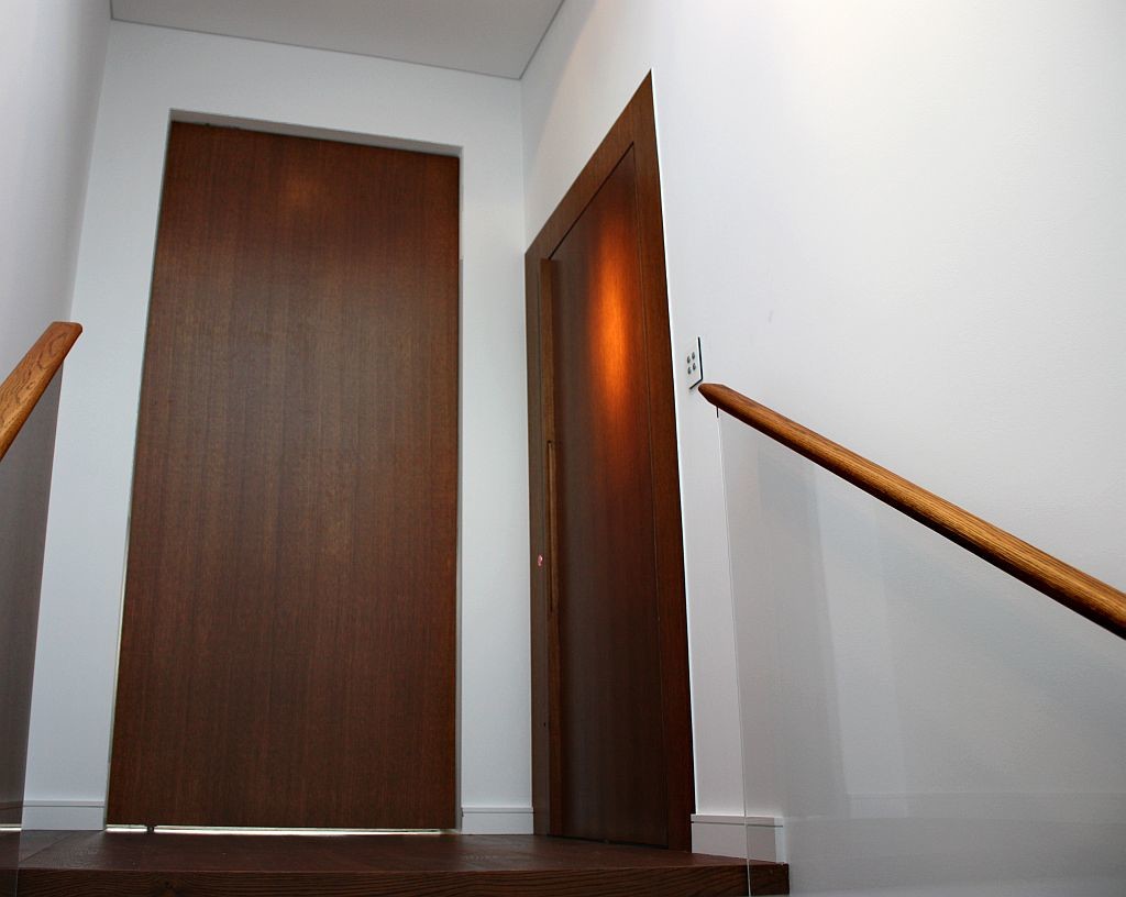 Lift Shop lift door concealed within the surrounding wall finish