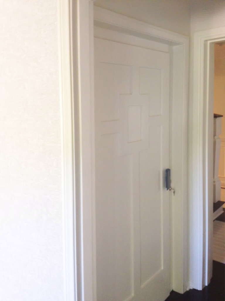 Lift Shop lift door concealed within the surrounding wall finish