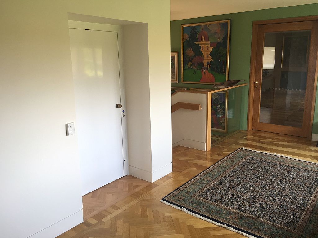 Lift Shop lift door concealed within the surrounding wall finish