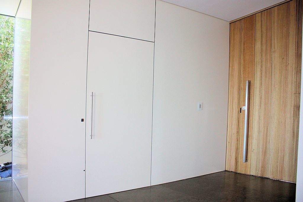 Lift Shop lift door concealed within the surrounding wall finish