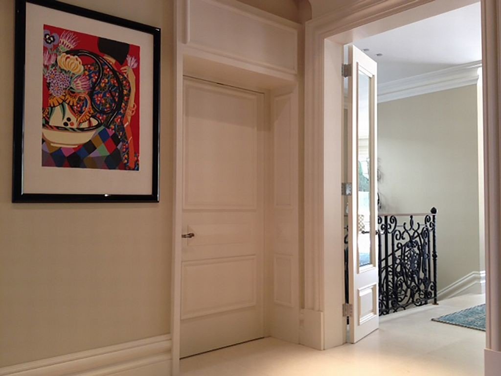 Lift Shop lift door concealed within the surrounding wall finish