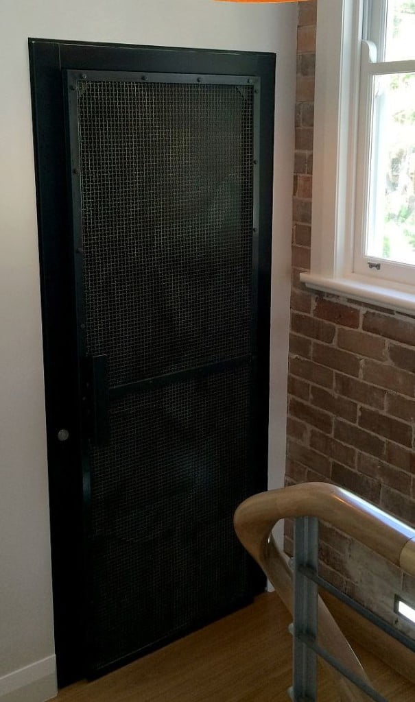 Lift Shop lift door concealed within the surrounding wall finish