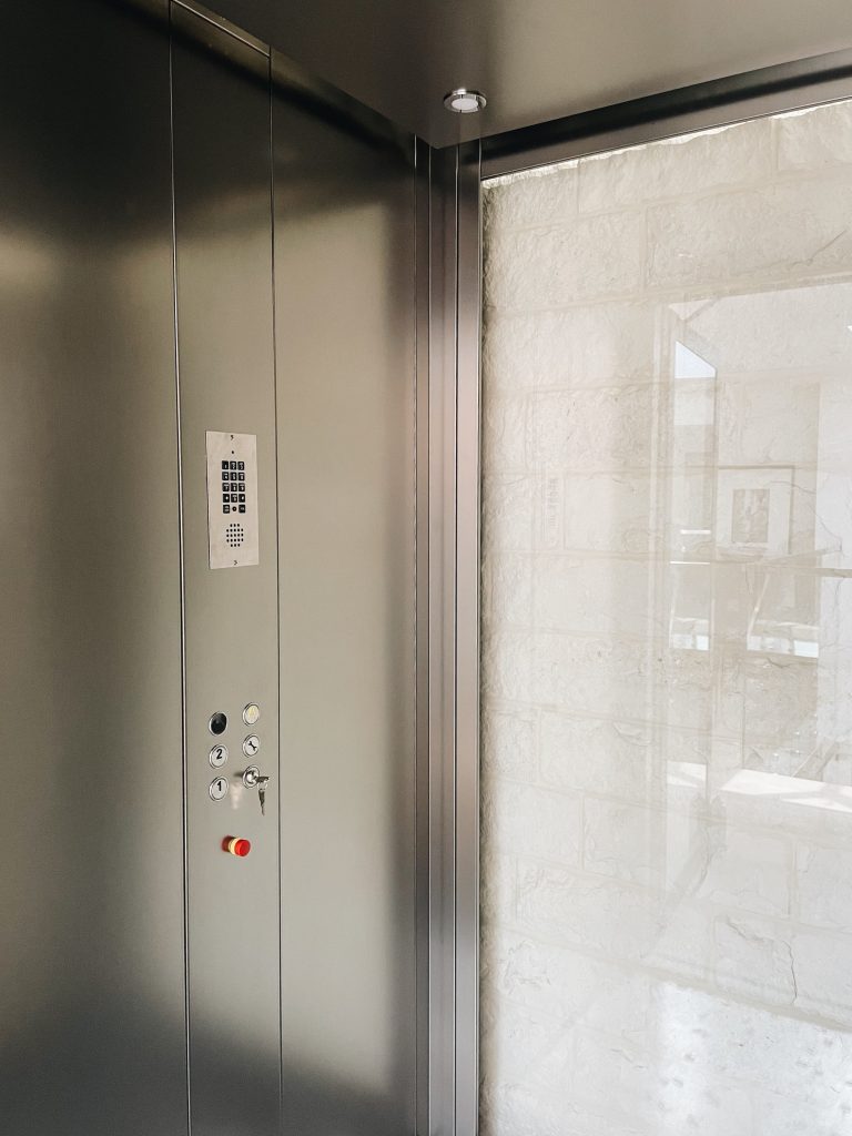 Brushed stainless control panel with floor buttons, key switch and keypad inside the Moderna cabin
