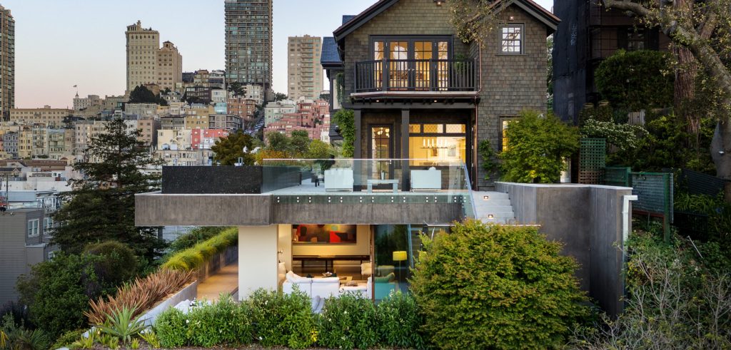 Terraced garden estate on Lombard Street with the San Francisco skyline behind it