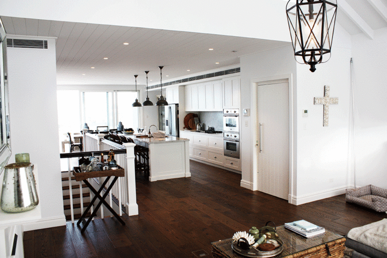 Open plan kitchen and living area with timber floors and a pendant lantern, Eastern Suburbs