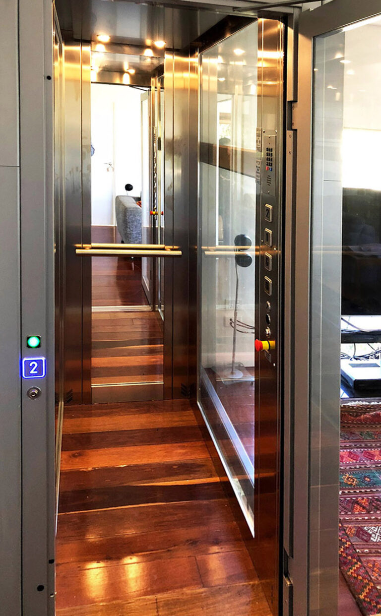 Looking into a glass home lift with a polished timber floor