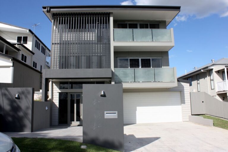 Three storey modern home with slatted screens and glass balconies in Brisbane