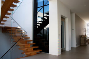 Brown staircase and lift in hallway