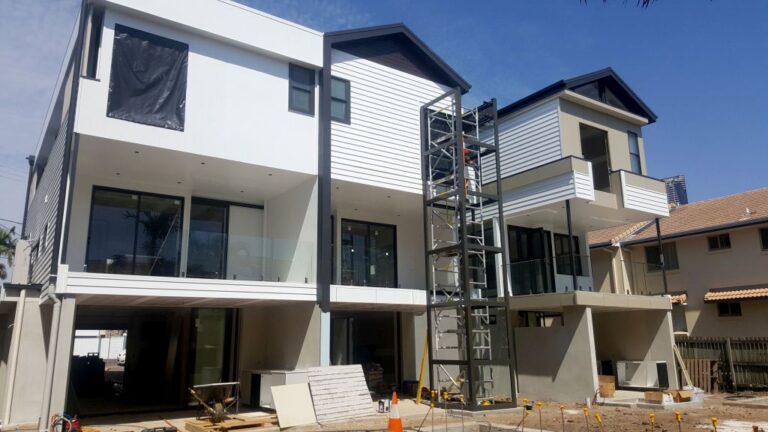 Rear of the New Farm townhouses under construction with a lift tower between them