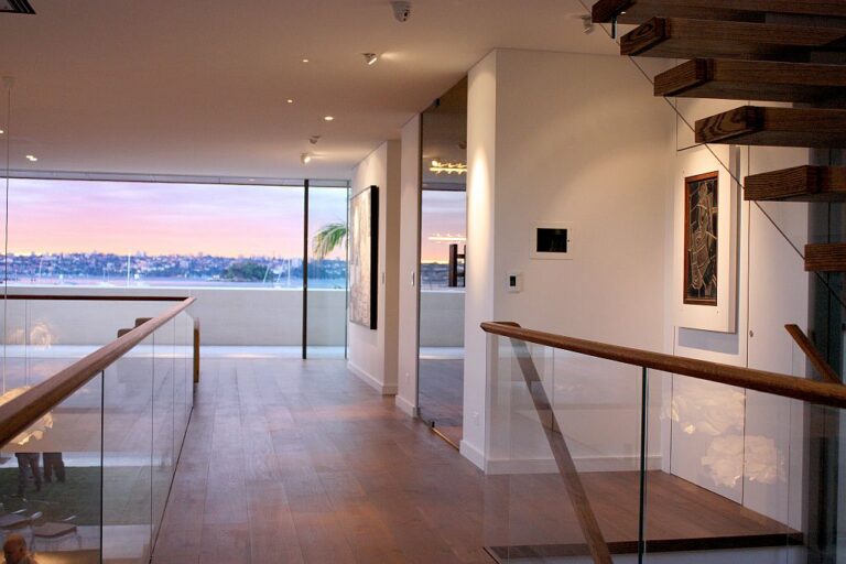 Glass balustrade landing with a harbour view at dusk in a Sydney Harbour home