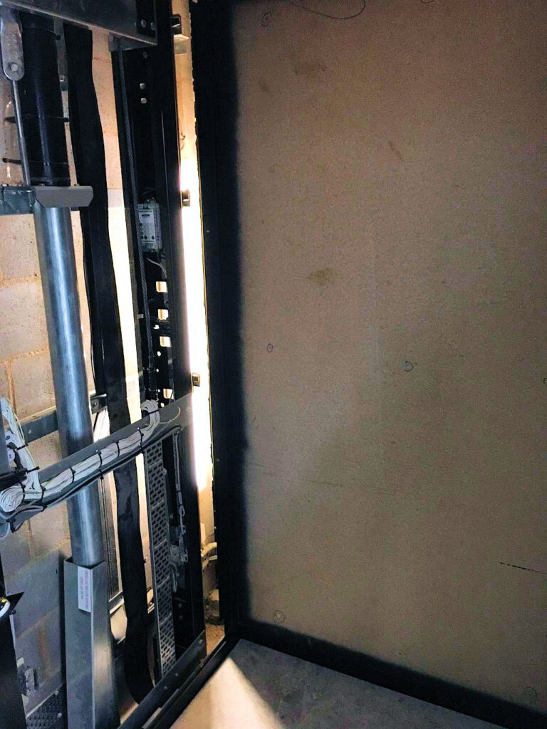Raw galvanised ElfoLift 2 cabin and shaft workings before the owner's finishes