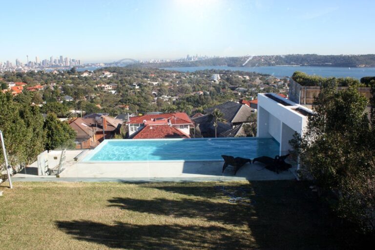 Harbour and city skyline viewed from a hillside garden with a swimming pool in Sydney