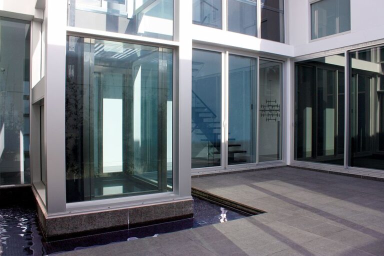 Glass lift enclosure in a courtyard beside a water feature in Dover Heights
