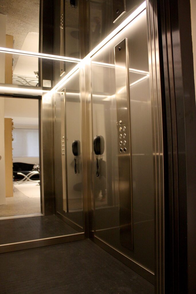 Stainless steel lift cabin with an LED light strip, mirrored panel and control panel