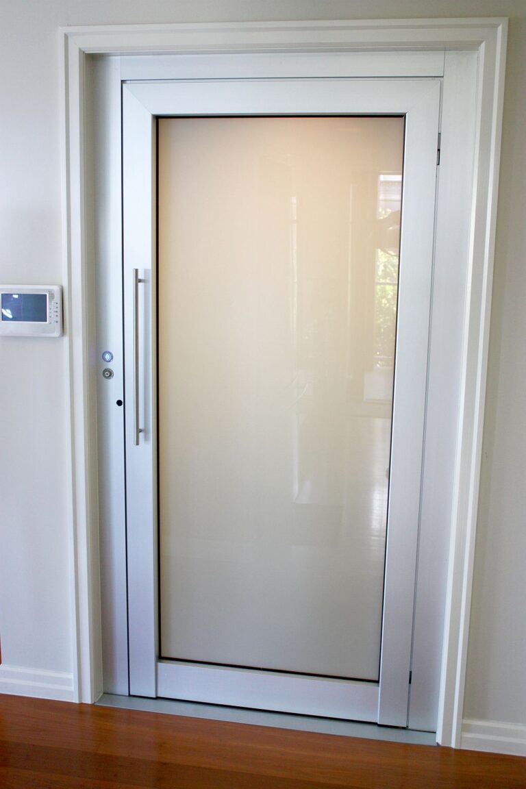 Frosted milk white glass ElfoLift door with a long handle in a white frame on a timber floor