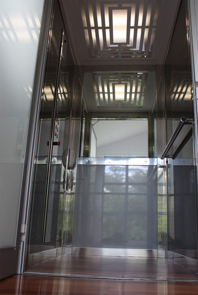 Looking up inside the ElfoLift cabin at the patterned LED ceiling light and mirrored walls