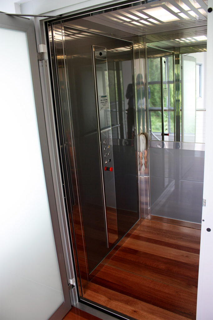 Looking into the stainless steel and glass ElfoLift cabin with its rosewood timber floor, Kenmore