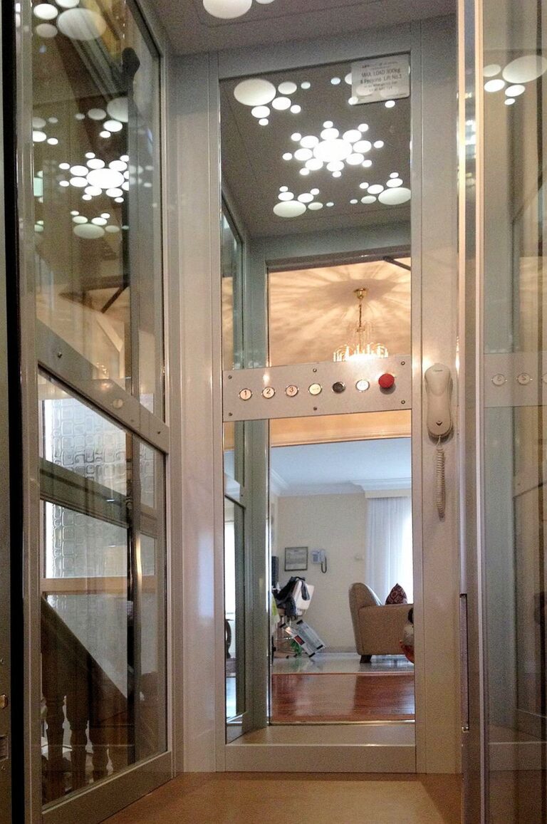 Glass lift door with snowflake pattern glass seen from a hallway