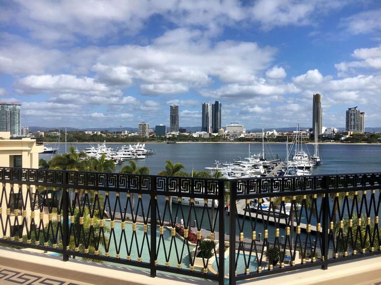Black and gold Greek key balcony railing at Palazzo Versace looking over the Main Beach marina