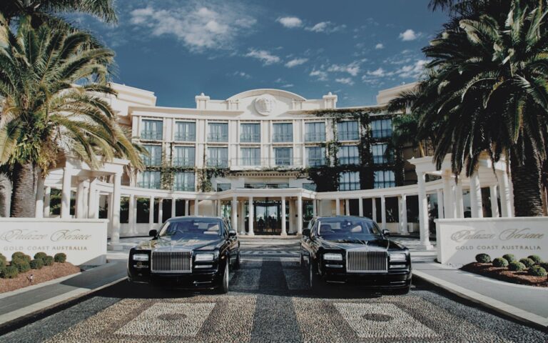 Palazzo Versace entrance with two cars and palm trees on the Gold Coast