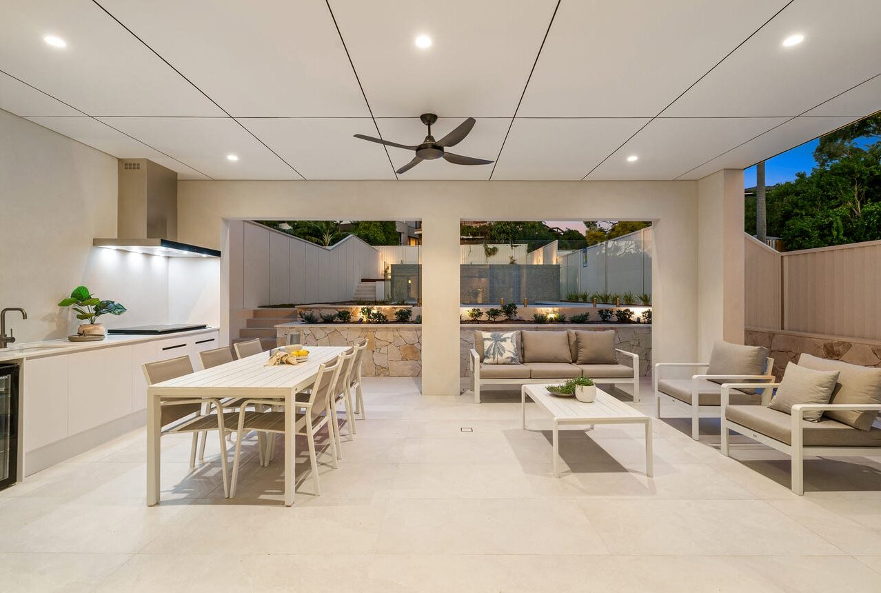 Outdoor entertaining area with kitchen and dining at Connells Point home