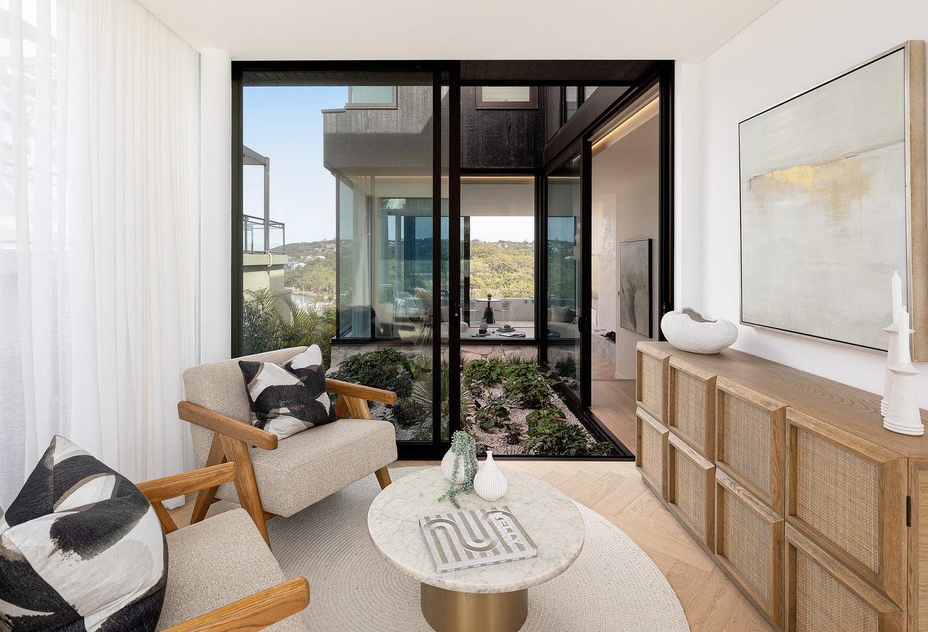 Modern lounge area with garden courtyard views in Fairlight residence