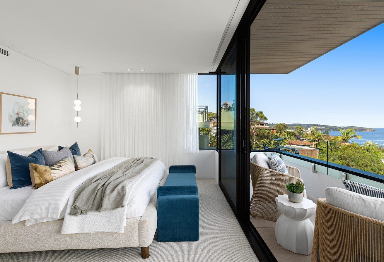 Master bedroom with balcony and ocean views at Fairlight residence