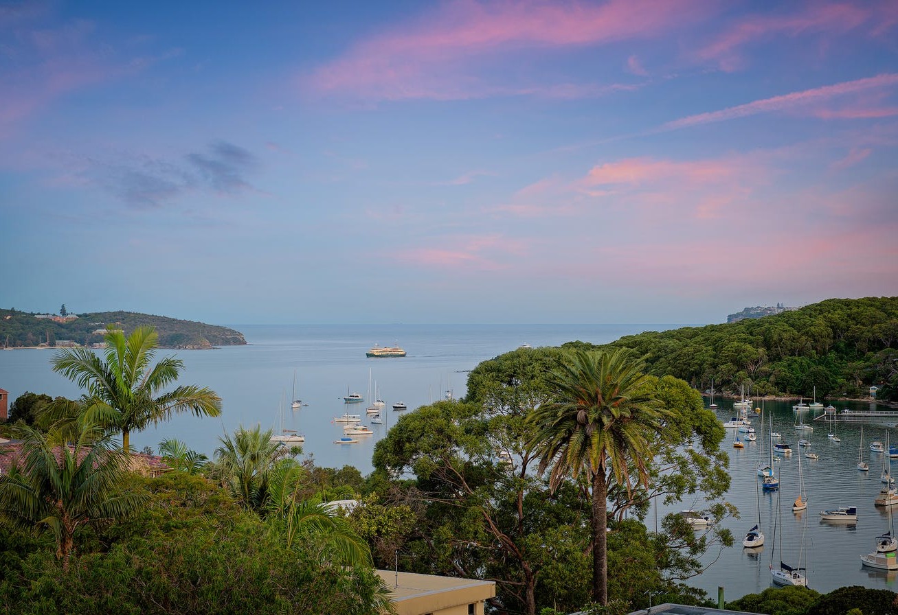 View over North Harbour and the boats at anchor from the Fairlight home at dusk