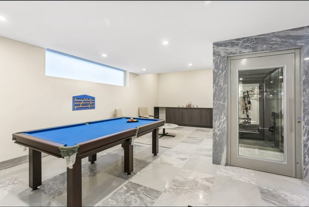 Stainless steel lift framed with grey and white marble
