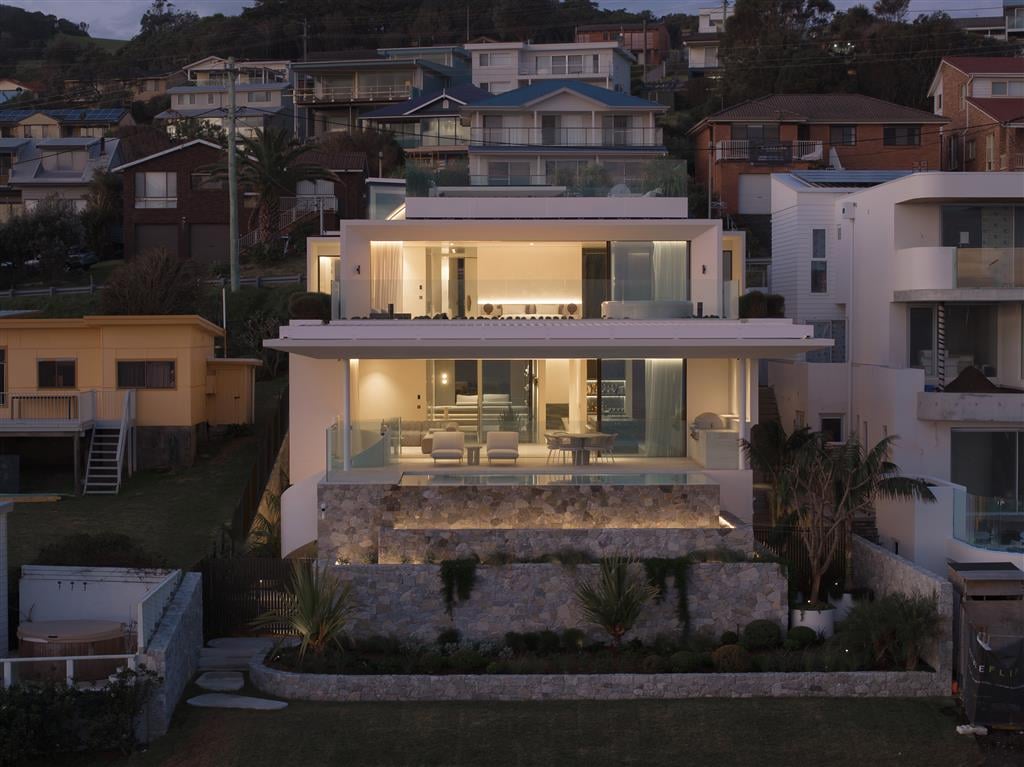 The Solstice exterior, HIA 2025 NSW Home of the Year winner by Futureflip, perched above Seven Mile Beach with ocean views.