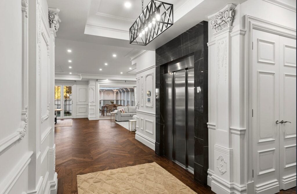 Balwyn luxury home entrance with centerpiece black marble framed stainless steel lift