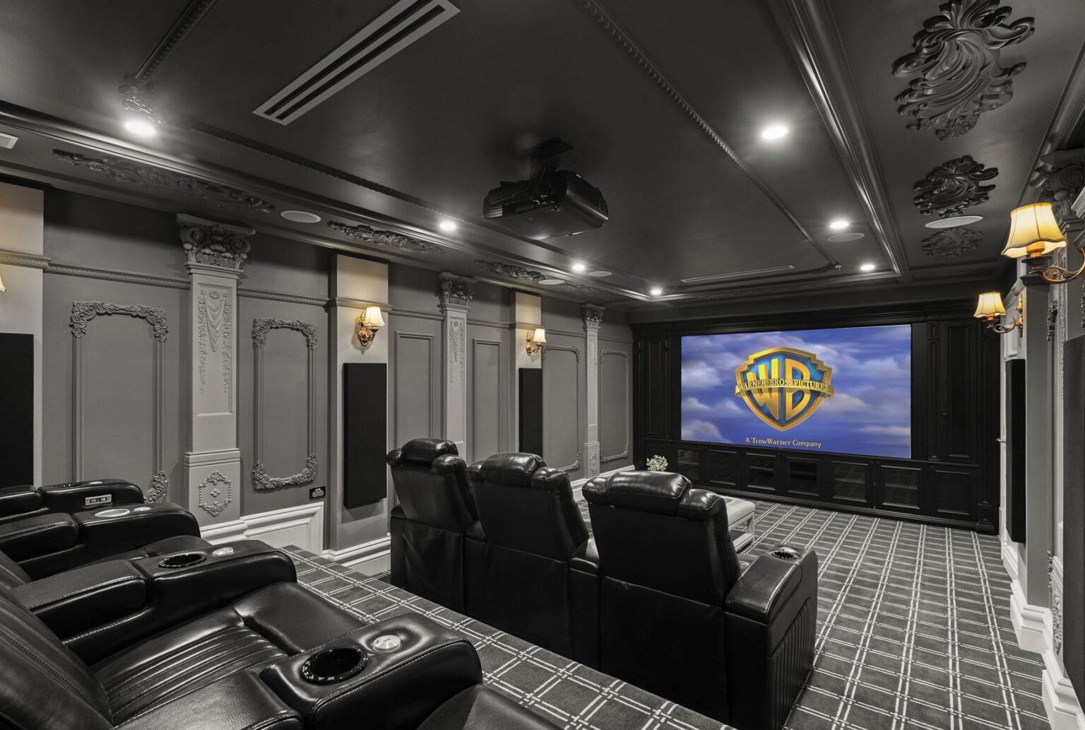 Private cinema room with black leather recliners and ornate grey panelling in a Balwyn luxury home