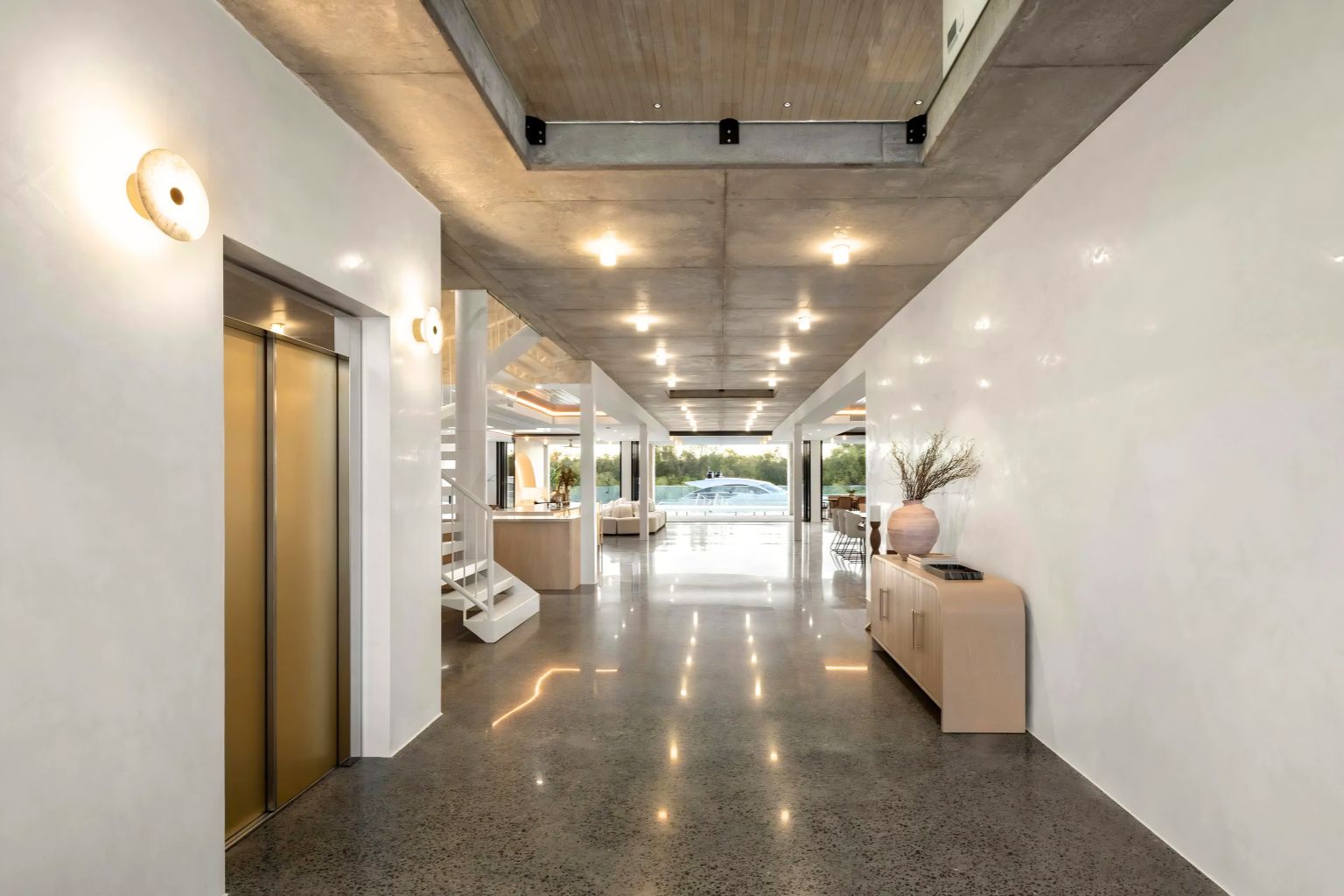 Lift Shop automatic sliding door home lift in a modern concrete hallway