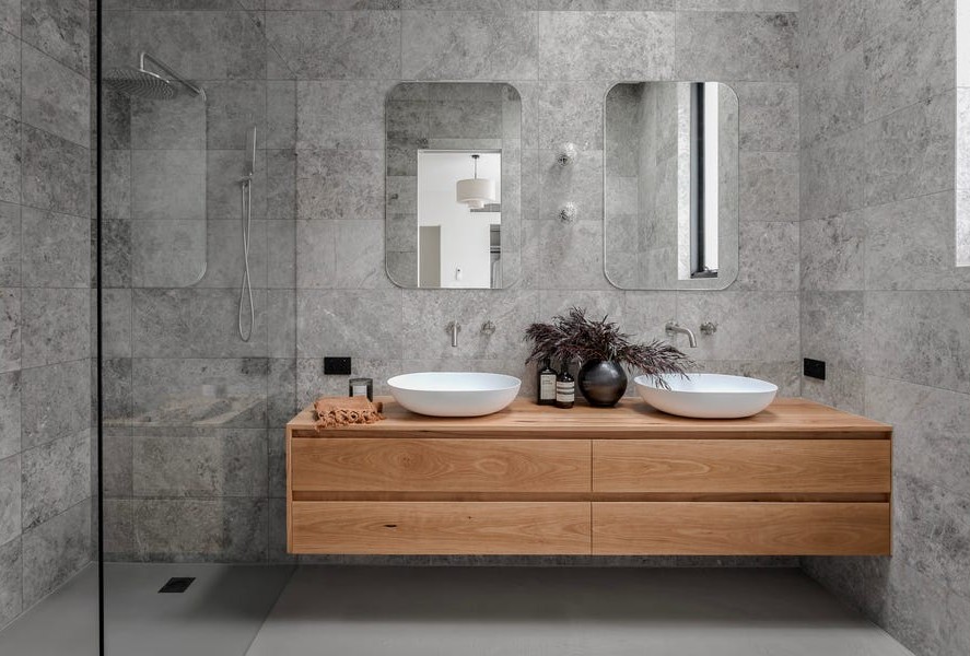Premium bathroom with stone finishes and floating timber vanity in architect-designed Kew home