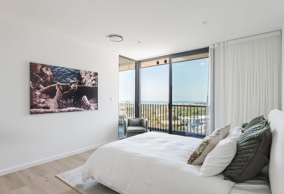 Luxury bedroom with ocean views in architect-designed Thirroul residence