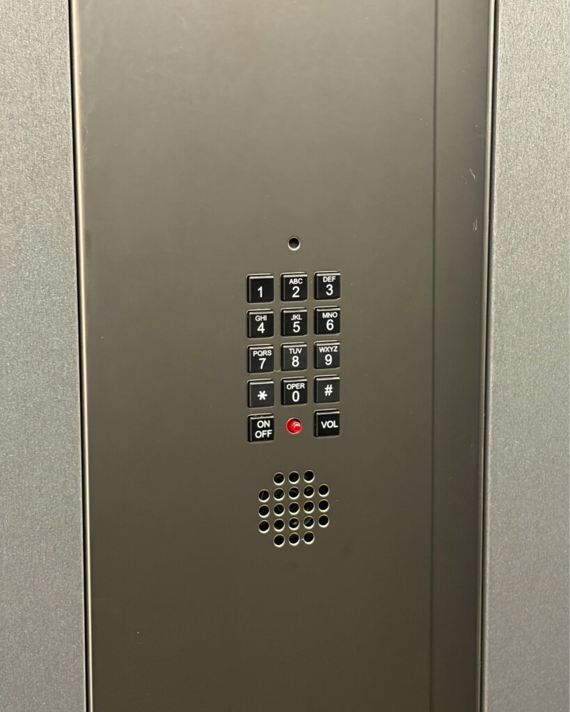 Integrated flush-mounted emergency phone keypad and speaker in a Lift Shop cabin control panel