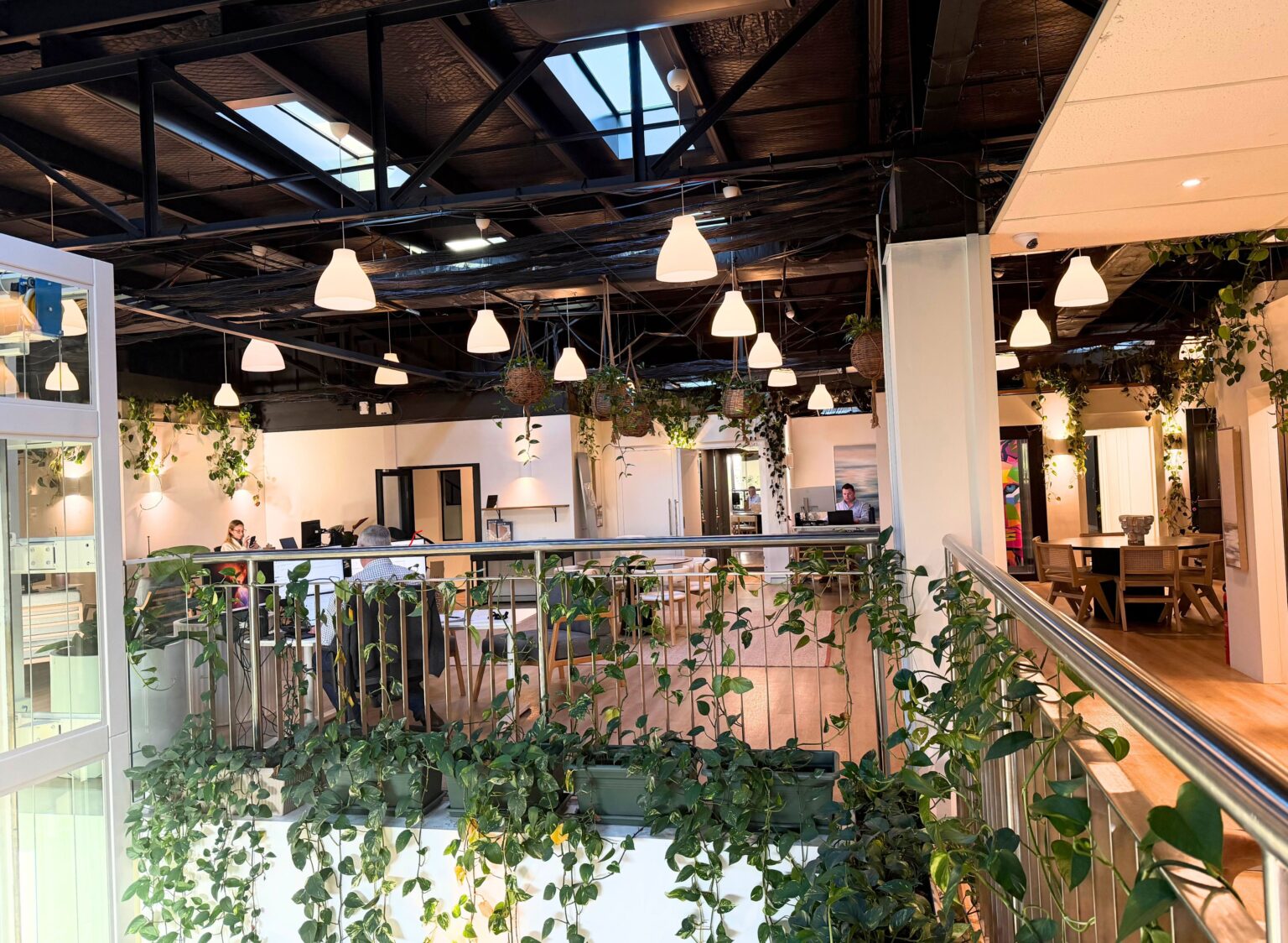 Upstairs lounge and meeting area with pendant lights and hanging plants in the Lift Shop Sydney showroom