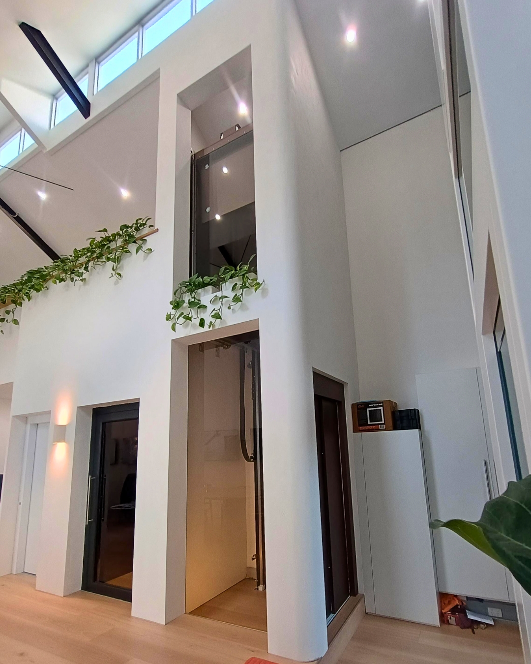 C Series home lift in brushed bronze moving between levels
