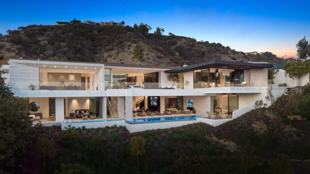 Dusk view of the multi-level modern home set into the Beverly Hills hillside