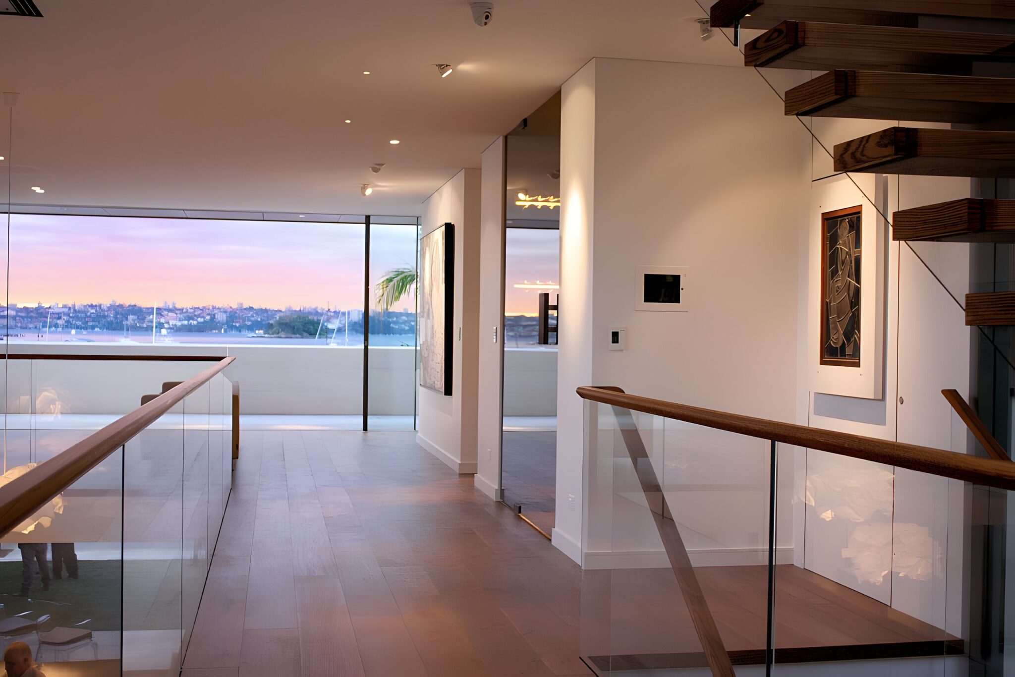 Glass balustrade landing with a harbour view at dusk in a Sydney Harbourside home