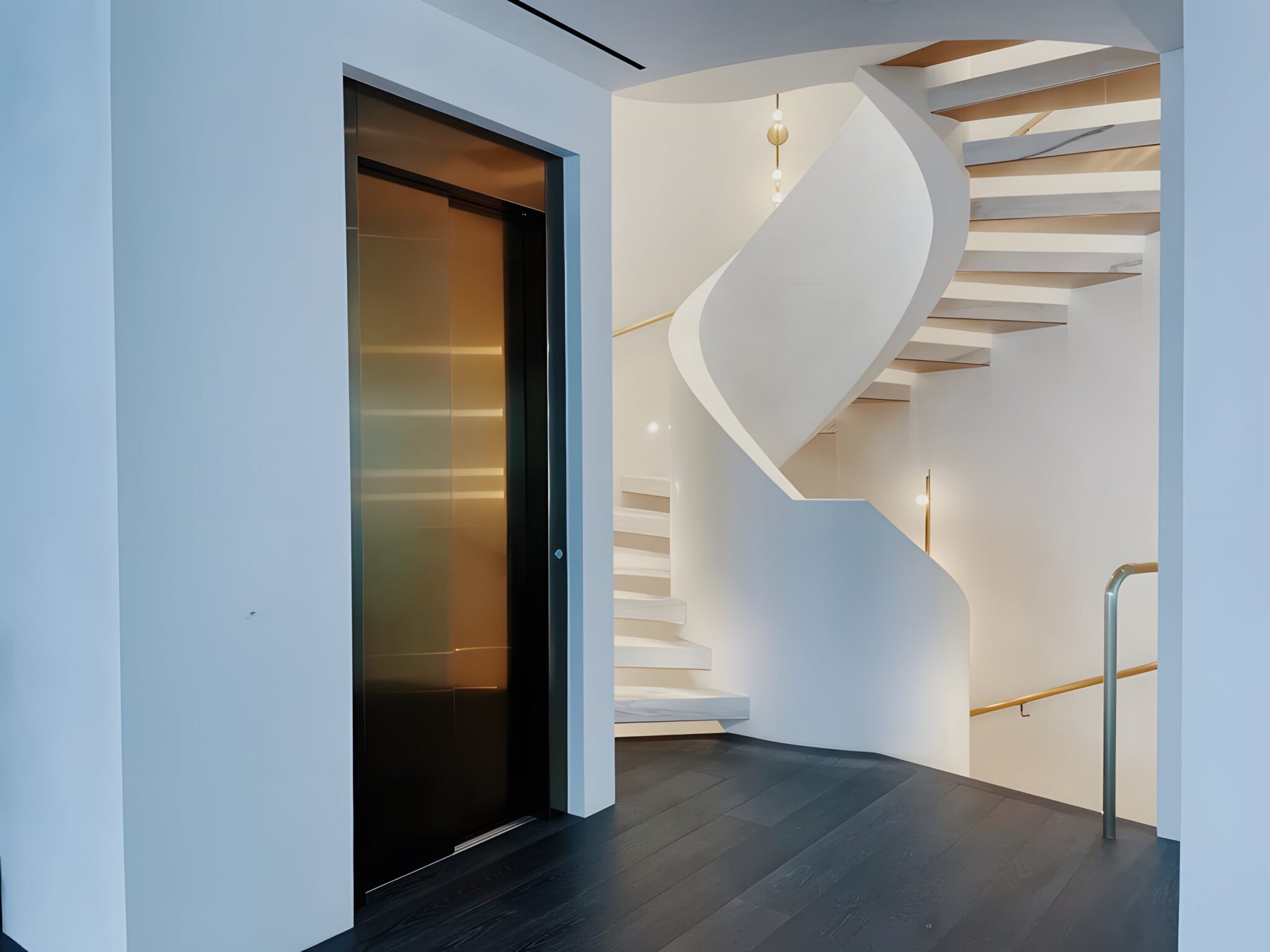 Bronze stainless steel lift door beside a white sculptural spiral staircase in a Laguna Beach home