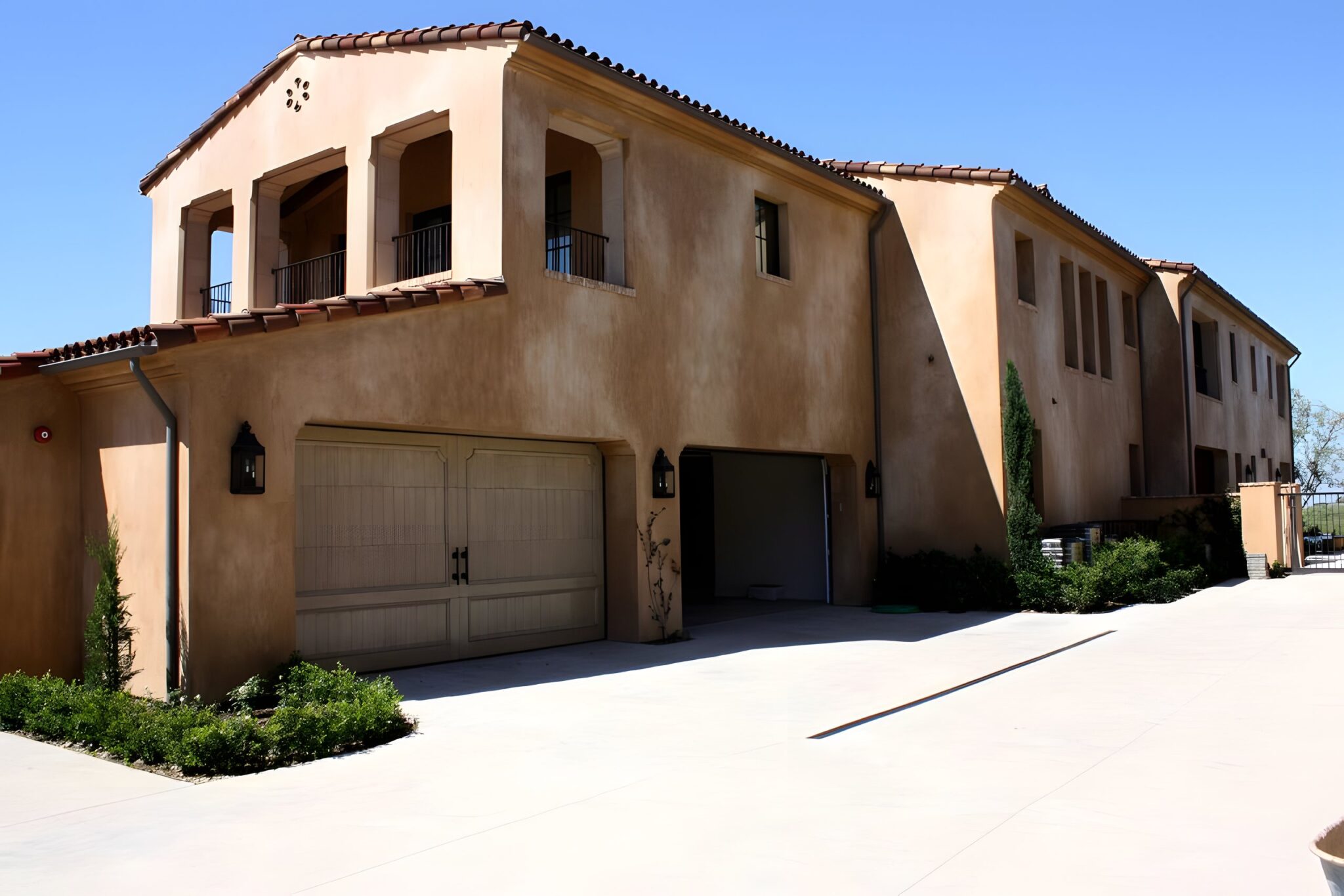 Two storey Spanish style house with a tiled roof and double garage in Newport Coast