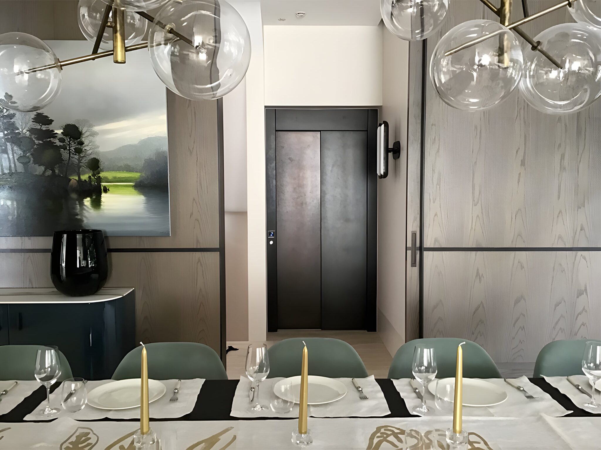 Black bronze-toned lift door at the end of a hallway beyond a set dining table in a Bellevue Hill home