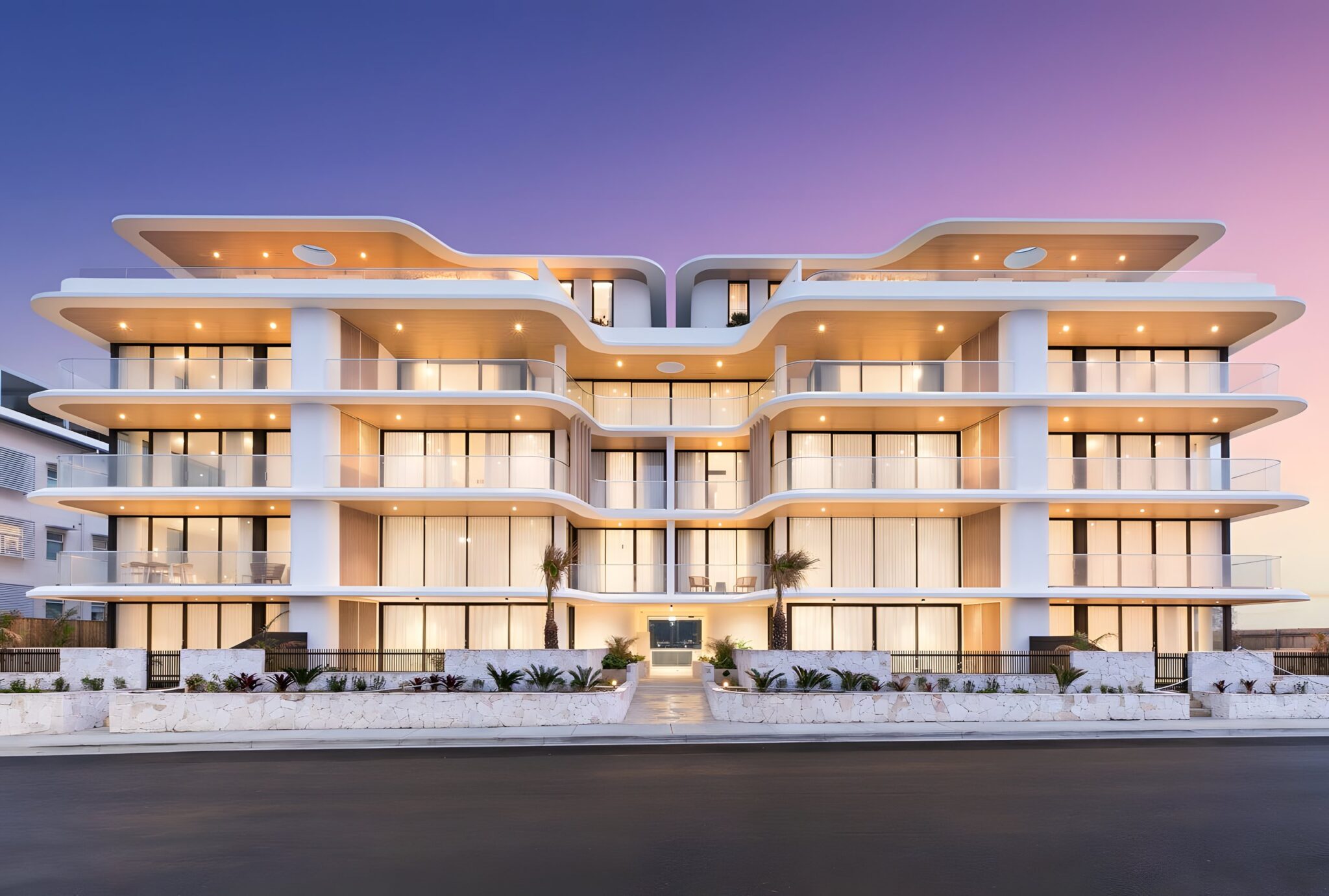 Solstice apartments on Prince Street, Cronulla, with curved white balconies lit at dusk
