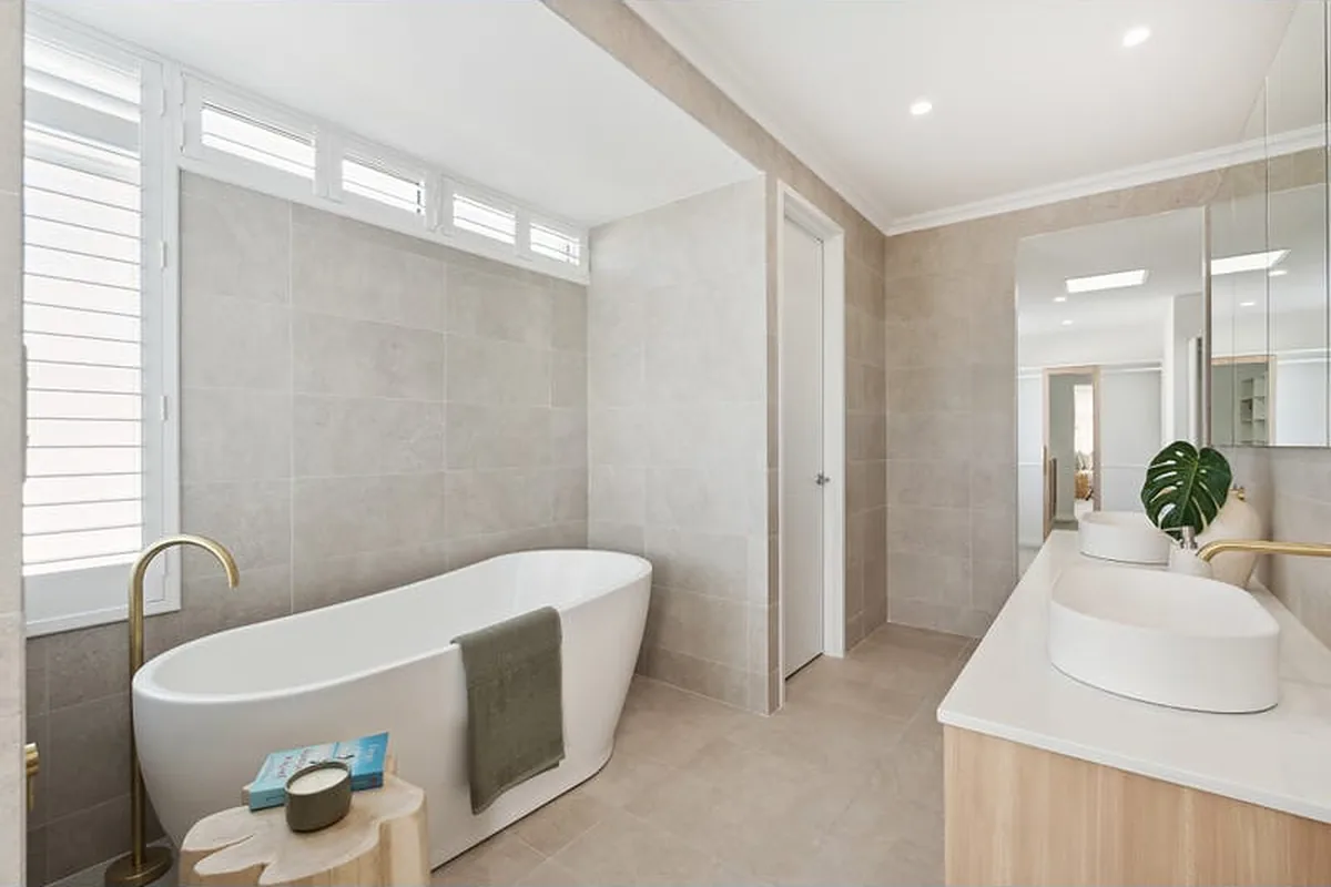 Bathroom with freestanding bath and brass tapware in a Marmion home