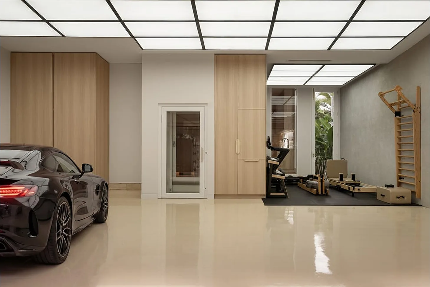 White glass-panelled home lift door in a New Farm garage beside a home gym White glass-panelled home lift door in a New Farm garage beside a home gym