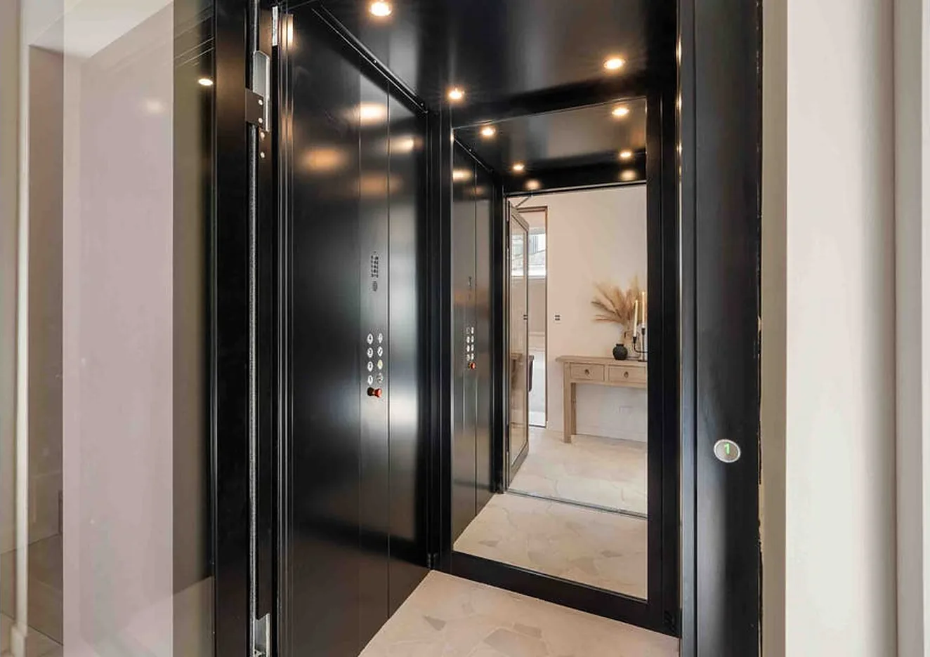 Black A Series lift cabin with mirror panel and open door in Palm Beach
