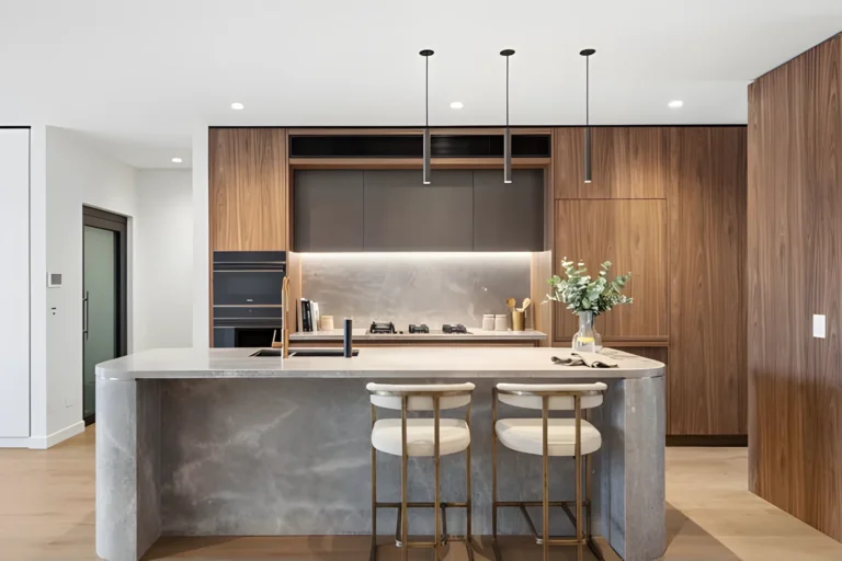 Kitchen with stone island and timber joinery in a Sanctuary Cove home