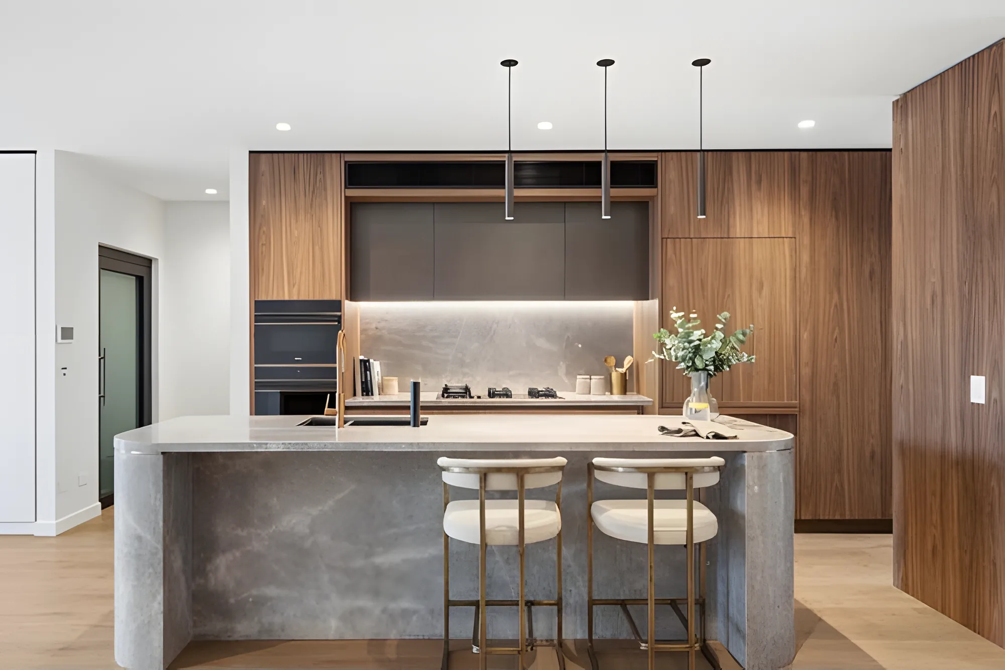 Kitchen with stone island and timber joinery in a Sanctuary Cove home